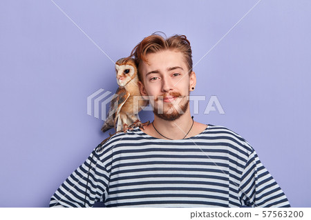 cheerful happy salesman selling an owl 57563200