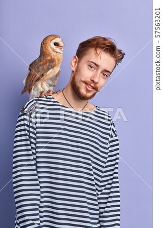 young ginger ornitologist takes care of birds 57563201