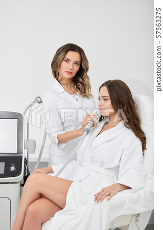 doctor improving the skin of patient 57563275