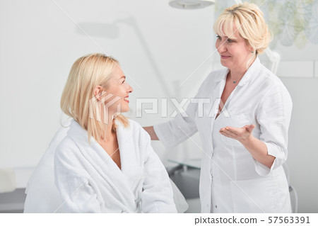 friendly conversation between a client and a doctor before procedure friendly conversation between a client and a doctor before procedure 57563391