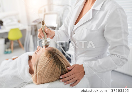 woman helping client to get rid of wrinkles 57563395