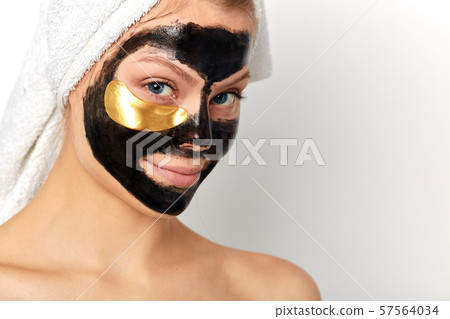 good looking cheerful girl with bare shoulders and a white towel on her head good looking cheerful girl with bare shoulders and a white towel on her head 57564034