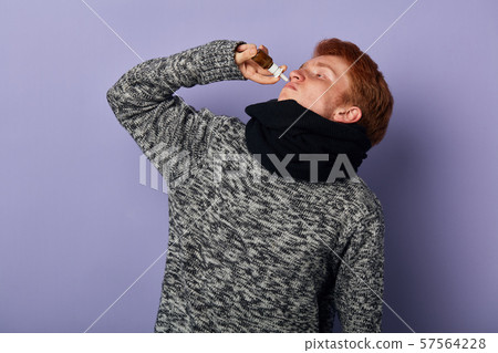 young man has cought cold in winter young man has cought cold in winter 57564228