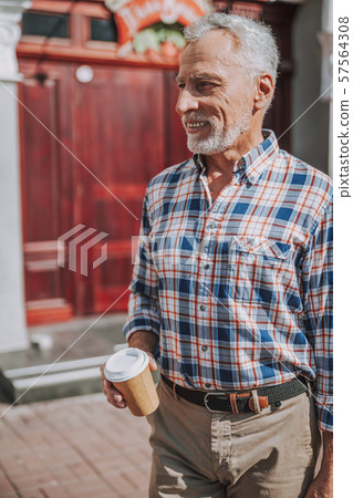 Smiling mature man with coffee to go stock photo Smiling mature man with coffee to go stock photo 57564308