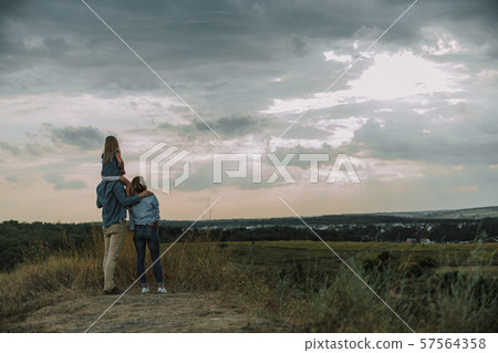 Young family is looking away on the hill 57564358