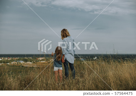 Young mother and little daughter on the field 57564475