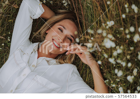 Happy pretty lady is resting on grass Happy pretty lady is resting on grass 57564533