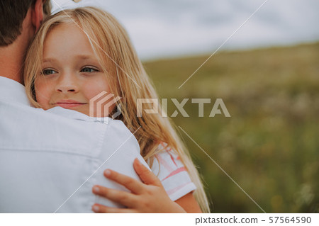 Pretty little daughter is hugging her father 57564590