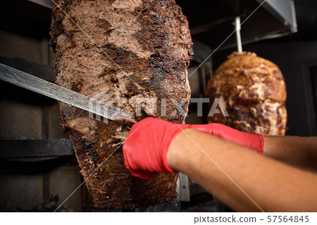 Fried meat on a skewer for cooking of donors or shawarma. Close-up 57564845