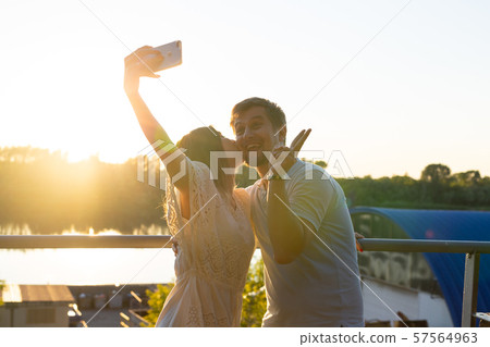 Beautiful funny romantic couple on nature background. Attractive young woman and handsome man are 57564963