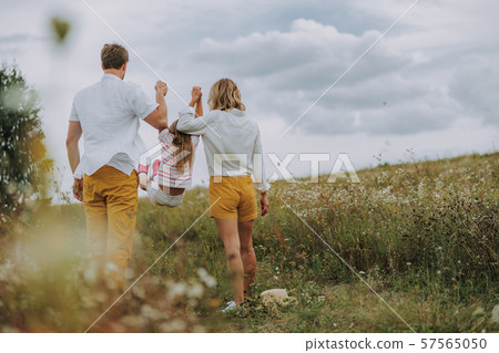 Parents raising their daughter by the hands Parents raising their daughter by the hands 57565050