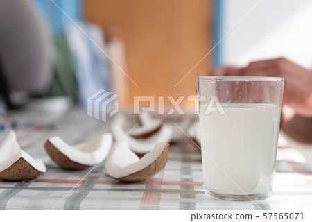 Coconut water and fresh pieces coconut on the table. Exotic food form Dominican Republic Coconut water and fresh pieces coconut on the table. Exotic food form Dominican Republic 57565071