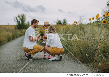 Little nice girl spending time with her family in the field 57565329