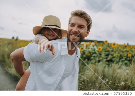 Little girl spending time with her dad in the field 57565330