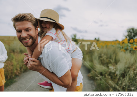 Small joyful daughter spending time with her dad near field Small joyful daughter spending time with her dad near field 57565332