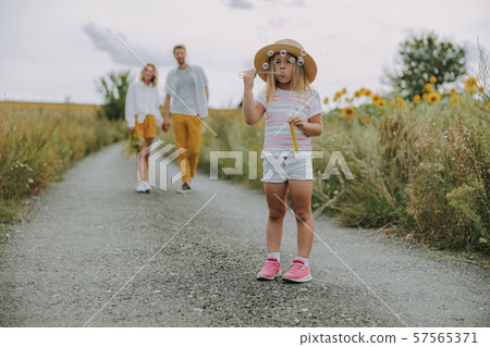 Blonde small girl enjoying her summer time outdoors Blonde small girl enjoying her summer time outdoors 57565371
