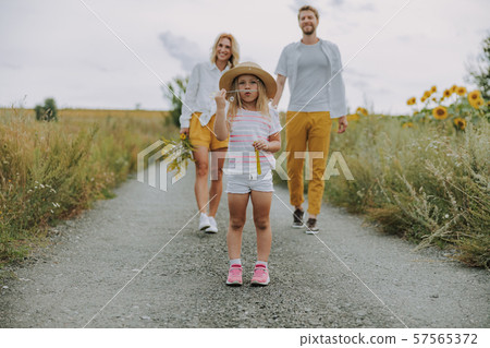 Blonde woman walking with her husband outdoors Blonde woman walking with her husband outdoors 57565372