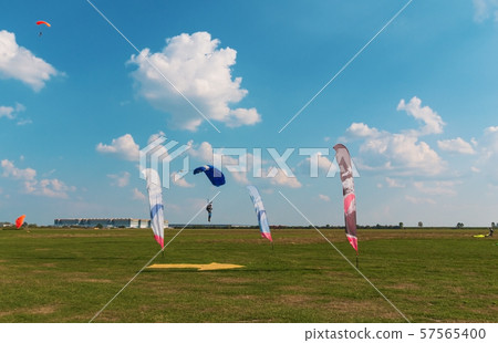 A men flying in the blue sky using parachute 57565400