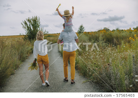 Young parents walking on the road outdoors 57565403
