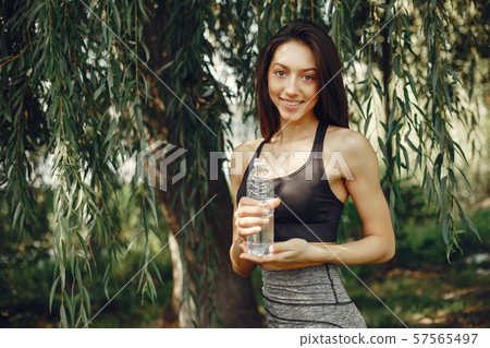 Beautiful sports girl in a summer park 57565497