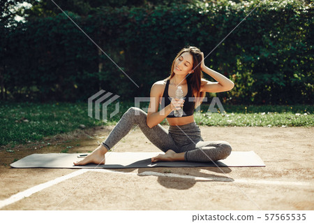 Beautiful sports girl in a summer park Beautiful sports girl in a summer park 57565535