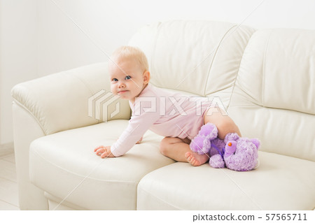 Children, infant and childhood concept - beautiful smiling baby is playing Children, infant and childhood concept - beautiful smiling baby is playing 57565711
