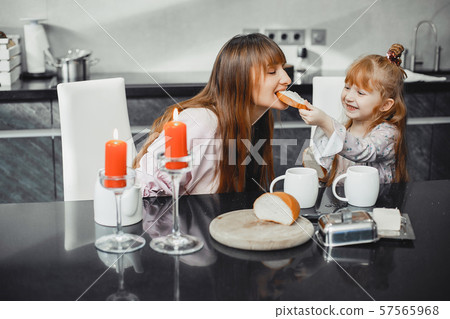 Mother with daughter in a kitchen Mother with daughter in a kitchen 57565968