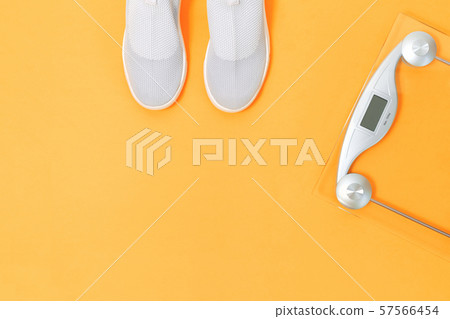 Textile sport shoes with weighing scale on saffron yellow Textile sport shoes with weighing scale on saffron yellow 57566454