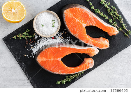 Two uncooked salmon steaks Two uncooked salmon steaks 57566495