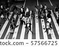 Black and white photo of people crossing the pedestrian crossing 57566725