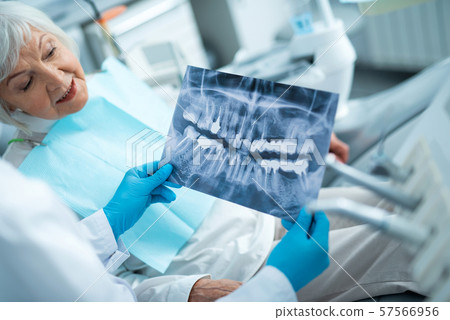 Happy adult female is looking on x-ray 57566956