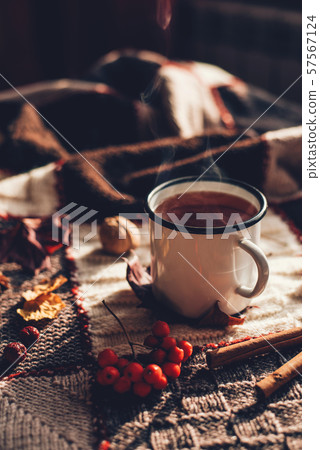 Autumn hot steaming cup of coffee or tea. 57567124