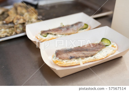 The counter on which lies a fish sandwich in an 57567514