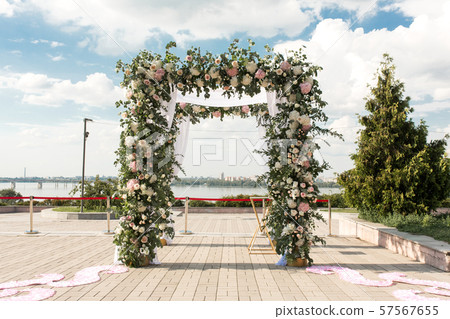 A festive chuppah decorated with fresh beautiful A festive chuppah decorated with fresh beautiful 57567655