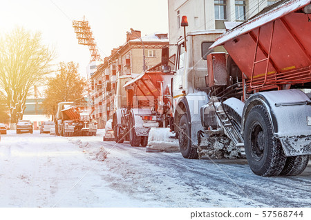 Snow plow removing snow from the city road. Snowplow truck working in the street 57568744