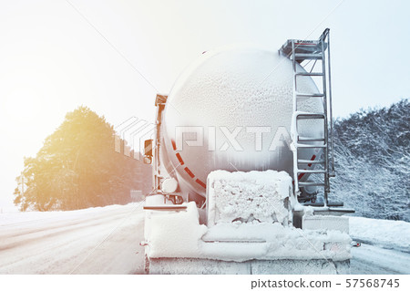 Truck with cargo tank on a slippery snow winter road outside the city 57568745