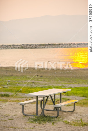 Table and bench with view of Lake Utah at sunset 57568919