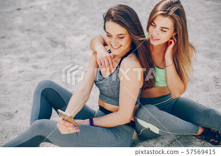 Two girls on a beach Two girls on a beach 57569415