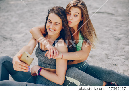 Two girls on a beach Two girls on a beach 57569417