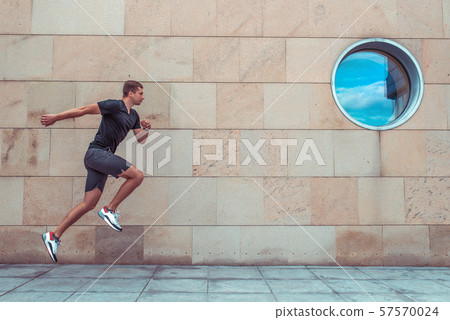 man summer i city, jogging jump. Active lifestyle, fitness workout, motivation in motion, fast and man summer i city, jogging jump. Active lifestyle, fitness workout, motivation in motion, fast and 57570024