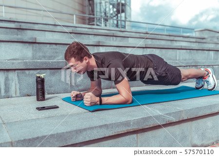 Male athlete, stands in bar, training muscles of back and abs, lifestyle fitness style will rob Male athlete, stands in bar, training muscles of back and abs, lifestyle fitness style will rob 57570110