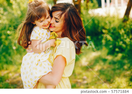 mother with daughter in a solar park mother with daughter in a solar park 57571884