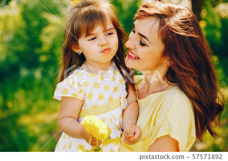 mother with daughter in a solar park mother with daughter in a solar park 57571892