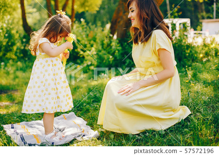 mother with daughter in a solar park 57572196