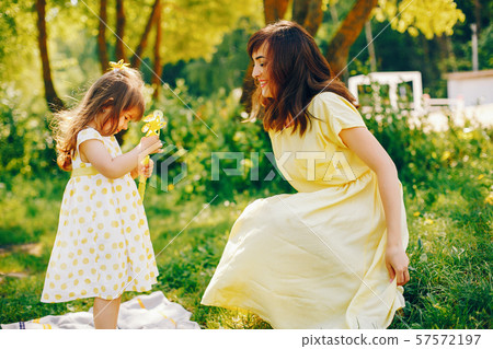 mother with daughter in a solar park 57572197