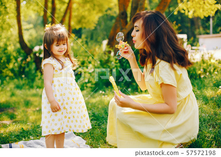 mother with daughter in a solar park mother with daughter in a solar park 57572198