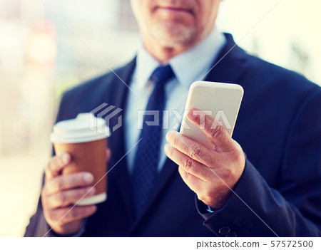 senior businessman with smartphone and coffee senior businessman with smartphone and coffee 57572500