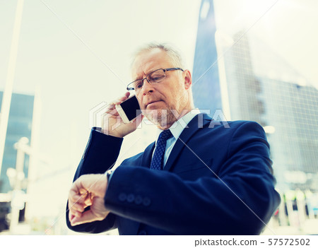 senior businessman calling on smartphone in city senior businessman calling on smartphone in city 57572502