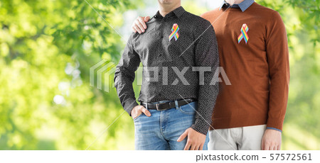 close up of couple with gay pride rainbow ribbons close up of couple with gay pride rainbow ribbons 57572561