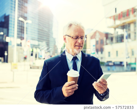 businessman with smartphone and coffee in city businessman with smartphone and coffee in city 57572833